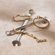 Gold Tiffany men's bracelets lie on top of wrenches
